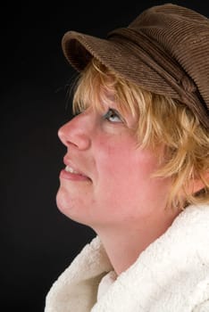 Beautiful girl with hat thinking and looking up.