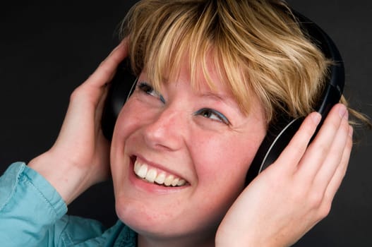 Girl listening to music on a headphone