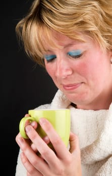Beautiful girl drinking hot coffee, it's getting colder.