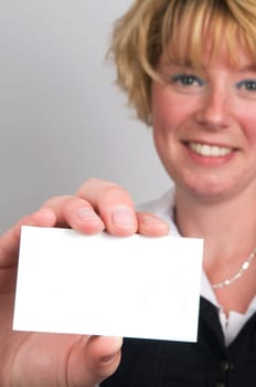 Young attractive business woman holding a white card