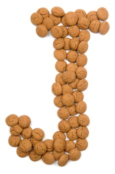 Little ginger nuts in the form of the letter J. These little ginger nuts are used in Holland for the "Sinterklaas"" party, which is at Dec 5 every year. Sinterklaas is a sort of Santa Claus. In Holland these ginger nuts are called ""pepernoot"". Isolated on white."
