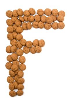 Little ginger nuts in the form of the letter F. These little ginger nuts are used in Holland for the "Sinterklaas"" party, which is at Dec 5 every year. Sinterklaas is a sort of Santa Claus. In Holland these ginger nuts are called ""pepernoot"". Isolated on white."