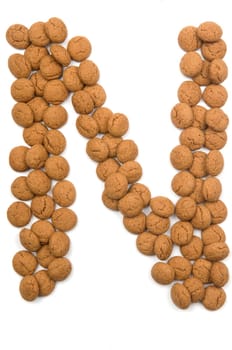 Little ginger nuts in the form of the letter N. These little ginger nuts are used in Holland for the "Sinterklaas"" party, which is at Dec 5 every year. Sinterklaas is a sort of Santa Claus. In Holland these ginger nuts are called ""pepernoot"". Isolated on white."