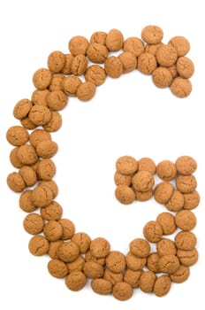 Little ginger nuts in the form of the letter G. These little ginger nuts are used in Holland for the "Sinterklaas"" party, which is at Dec 5 every year. Sinterklaas is a sort of Santa Claus. In Holland these ginger nuts are called ""pepernoot"". Isolated on white."