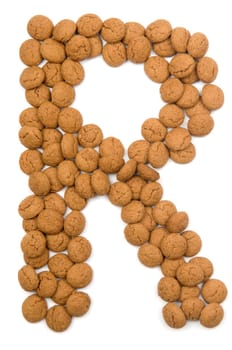 Little ginger nuts in the form of the letter R. These little ginger nuts are used in Holland for the "Sinterklaas"" party, which is at Dec 5 every year. Sinterklaas is a sort of Santa Claus. In Holland these ginger nuts are called ""pepernoot"". Isolated on white."