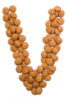 Little ginger nuts in the form of the letter V. These little ginger nuts are used in Holland for the "Sinterklaas"" party, which is at Dec 5 every year. Sinterklaas is a sort of Santa Claus. In Holland these ginger nuts are called ""pepernoot"". Isolated on white."