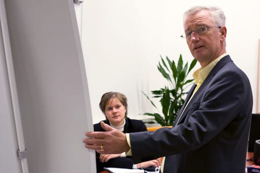 Business man showing a business plan to his employee