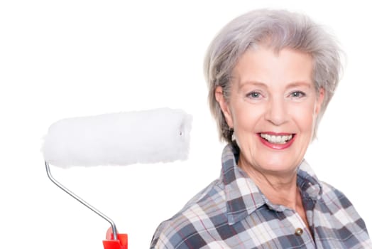 Studio shot of an elderly woman with a painter's role against a white background
