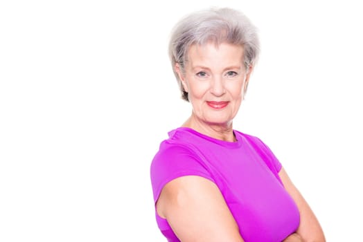 Studio recording of an active senior woman playing sports against a white background