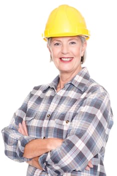 Studio shot of a senior woman wearing a yellow construction helmet against a white background