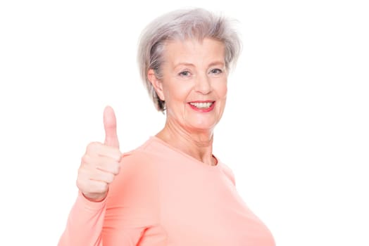 Studio recording of an active senior woman playing sports against a white background