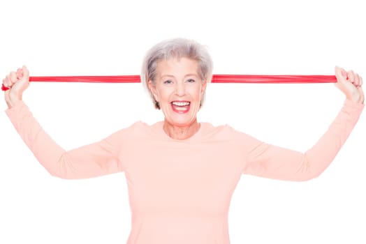 Studio recording of an active senior woman playing sports against a white background