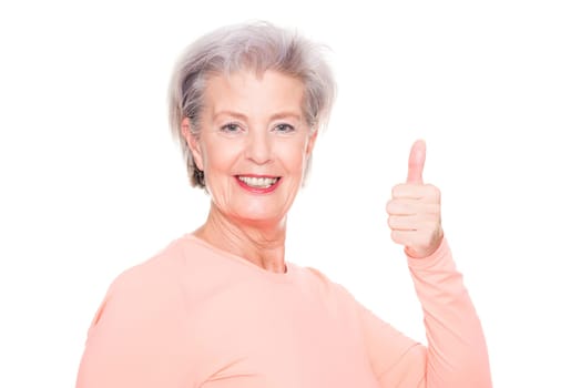 Studio recording of an active senior woman playing sports against a white background