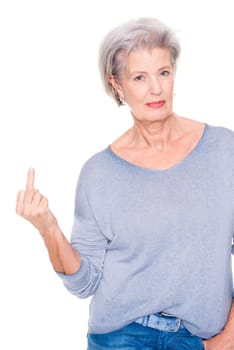 Elderly woman shows middle finger against white studio background