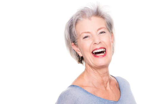 Studio recording of an active and happy senior against a white background