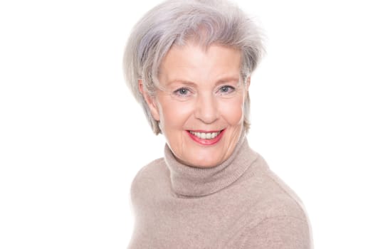 Studio recording of an active and happy senior against a white background