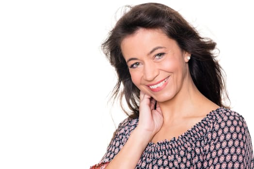 Smiling middle-aged woman against a white background