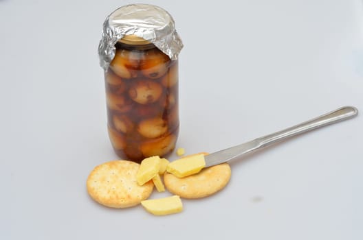 jar of home made pickled onions cheese and biscuits and knife