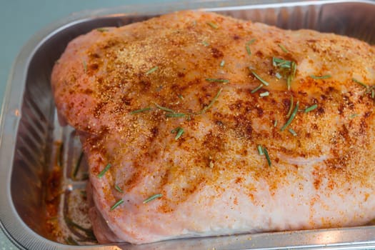 Raw duck ready seasoned in an aluminium bowl..
