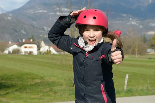 a teenage girl wearing a roller helmet.