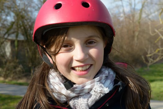 a teenage girl wearing a roller helmet.