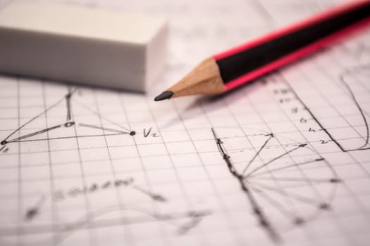 Pencil on notebook,   full of mathematical formulas