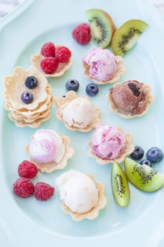 Various balls of ice cream in small bowls