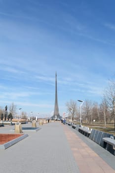 Moscow, Russia - March 29, 2016: Alley of Cosmonauts - memorial pedestrian street at the north of Moscow in front of the main entrance to The Exhibition of Achievements of National Economy (VDNH). At the end of the alley is a monument to Tsiolkovsky, followed by - the main monument "Conquerors of Space"""