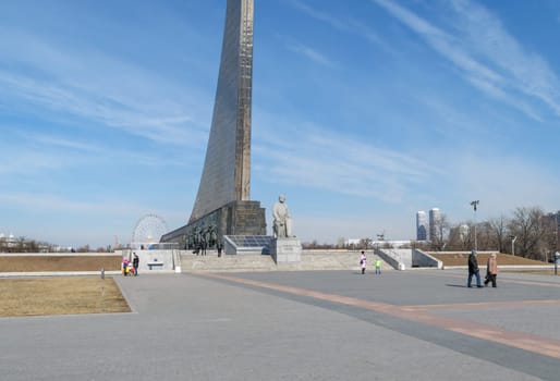 Moscow, Russia - March 29, 2016: People near the monument to the founder of astronautics Tsiolkovsky near the entrance of Memorial Museum of Cosmonautics on avenue of Cosmonauts