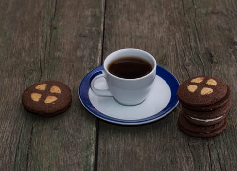 beautiful still life of coffee and cookies on an old table