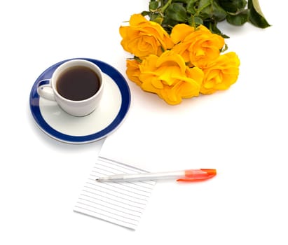 cup of coffee, yellow roses and notebook with the handle