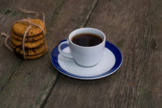white cup of coffee on a saucer with a blue border