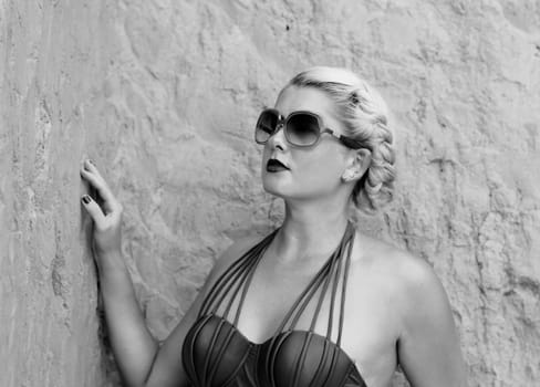 portrait of the beautiful woman at the rock, the black-and-white photo