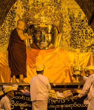 The ritual of daily face washing Mahamuni Buddha in Mandalay, Myanmar