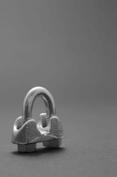 Steel screw carabiner isolated on dark background