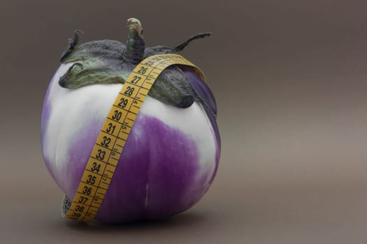 Fresh Ripe eggplant isolated on brown background to understand a concept of healthy eating
