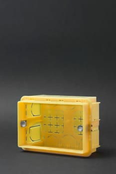 plastic electrical junction box isolated on dark background
