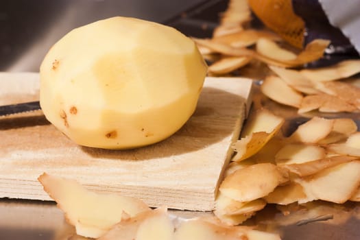 Closeup of a potato on a wooden cutting board as concept of healthy diet