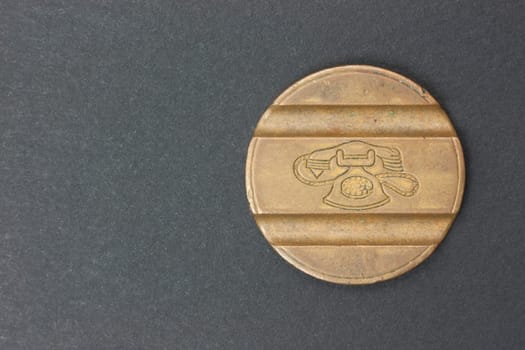 Ancient coin Italian telephone on a black background