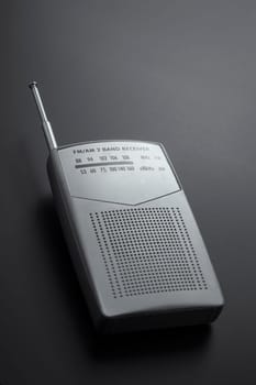 Portable radio receiver gray isolated on a dark background
