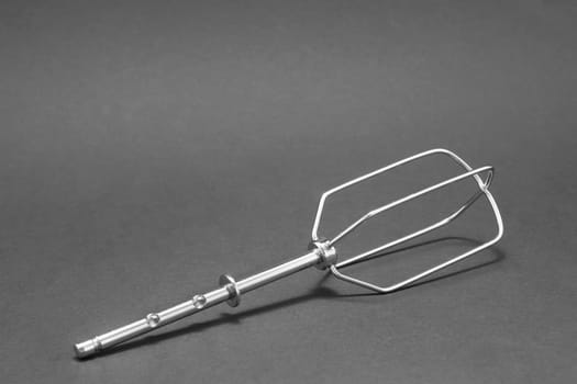 Single hand mixer manual egg beater on a gray background