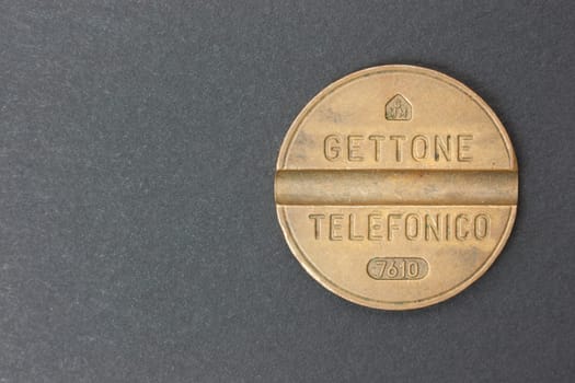 Italian telephone token on a black background