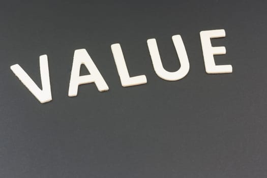 The value written with wooden urn on a black background