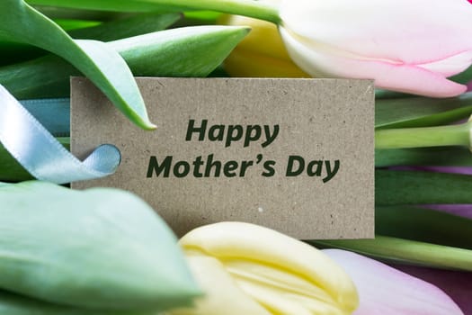 Happy Mother's day card among tulips.