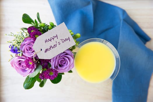 Mother Day greeting on a bouquet of flower with a Mimosa, seen from above.