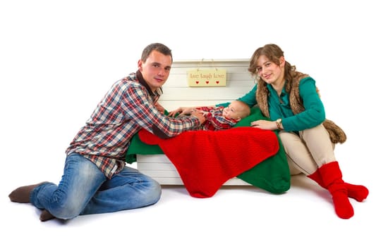 Baby boy in old box with his parents on white background