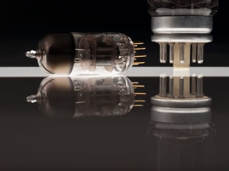 Vacuum tubes on black background  with reflection