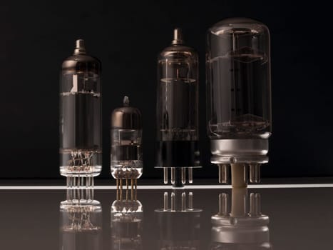 Vacuum tubes on black background  with reflection