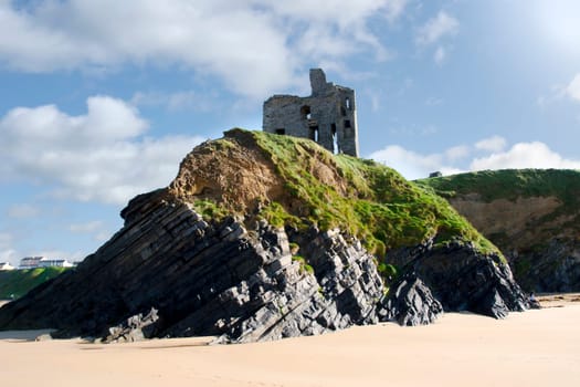 old historic castle on a cliff edge over the beach in Ballybunion county Kerry Ireland