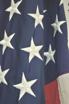 Patriotic holiday background of the american flag, closeup,low contrast for text overlay. Emblem of freedom and democracy.  Closeup of the stars and stripes of the flag of the United States of America.